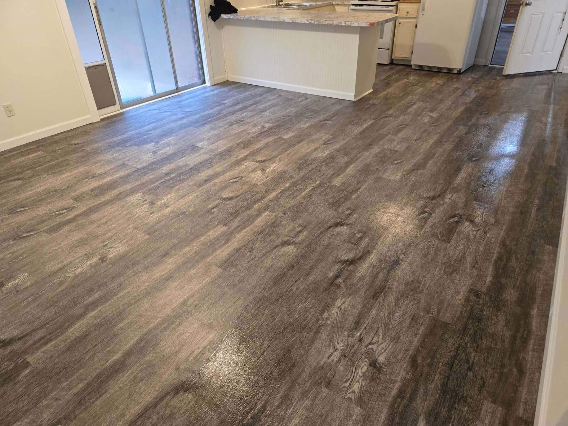 Bright kitchen Flooring Installation showcasing vinyl plank flooring in Pensacola